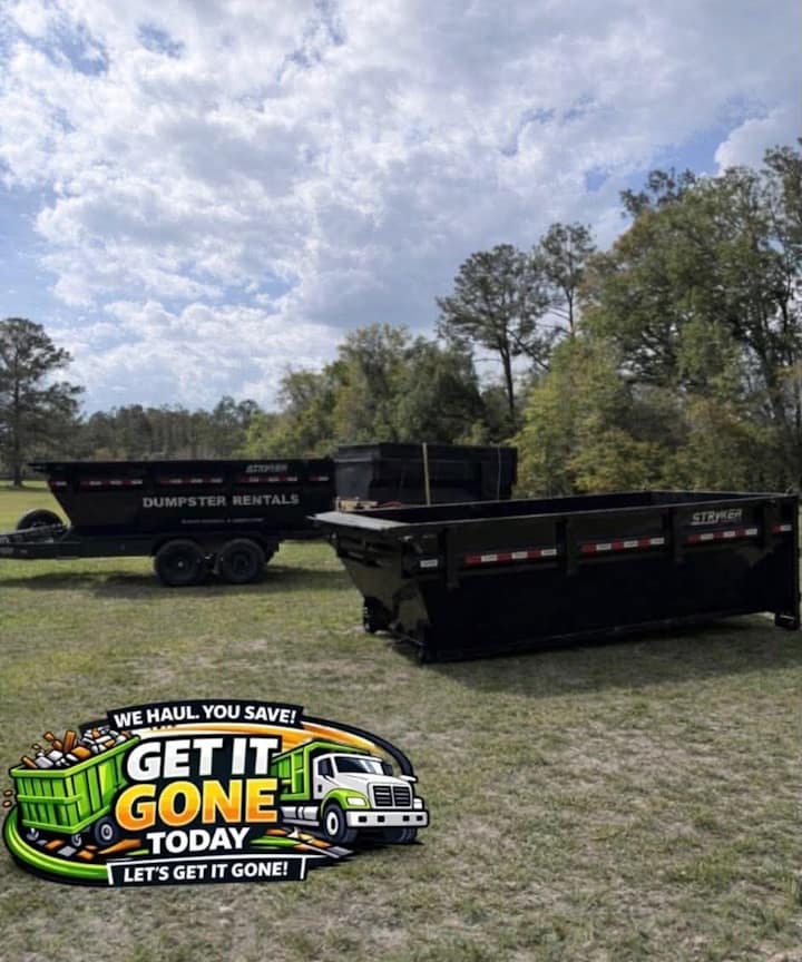 Get It Gone Today’s black dumpsters set out on a grassy property.